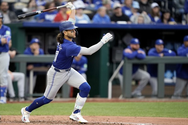 Toronto Blue Jays' Bo Bichette watches his three-run triple during the third inning of a baseball game Monday, April 22, 2024, in Kansas City, Mo. (AP Photo/Charlie Riedel)