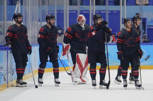 Team Canada players watch as Sweden players celebrate after Sweden won their men's quarterfinal hockey game at the 2022 Winter Olympics, Wednesday, Feb. 16, 2022, in Beijing. (AP Photo/Matt Slocum)