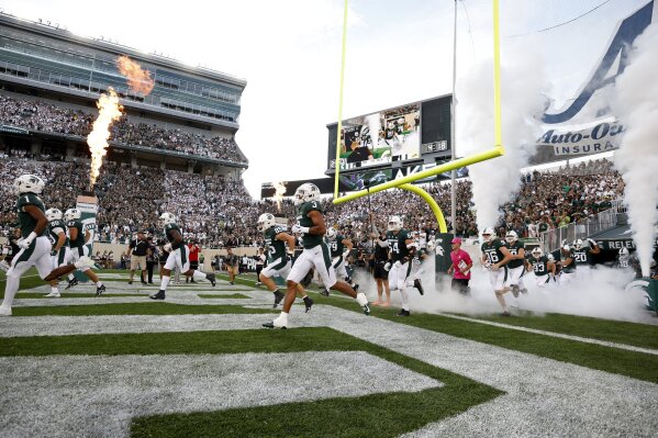 FILE - Michigan State players take the field before an NCAA college football game against Western Michigan, Friday, Sept. 2, 2022, in East Lansing, Mich. (AP Photo/Al Goldis, File)