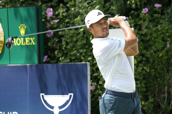 Xander Schauffele watches his tee shot on the first hole during the final round of the BMW Championship golf tournament, Sunday, Aug. 20, 2023, in Olympia Fields, Ill. (AP Photo/Charles Rex Arbogast)