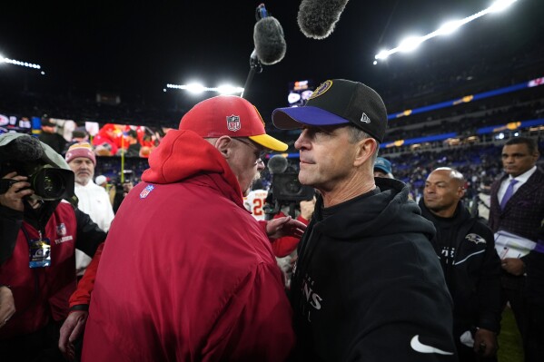 Kansas City Chiefs head coach Andy Reid and Baltimore Ravens head coach John Harbaugh, right, meet after the Chiefs won the AFC Championship NFL football game, Sunday, Jan. 28, 2024, in Baltimore. (AP Photo/Matt Slocum)