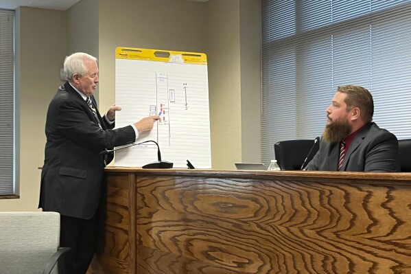 Attorney Timothy Uhrich, left, with the Pennsylvania State Coroners Association, speaks with Deputy Washington County Coroner Matthew Yancosek during an inquest into the death of Eduardo Hoover Jr., Tuesday, Oct. 24, 2023, in Washington, Pa. The Washington County coroner is calling for an involuntary manslaughter charge against a police officer who shot and killed Hoover after a car chase earlier this year, but the county's district attorney maintains the shooting was justified. (Jon Andreassi/Observer-Reporter via AP)