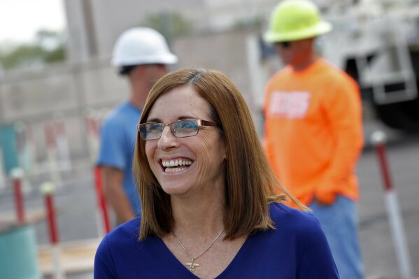 
              U.S. Rep. Martha McSally, R-Ariz., who is running against U.S. Rep. Kyrsten Sinema, D-Ariz., for the senate seat being vacated by retiring U.S. Sen. Jeff Flake, R-Ariz., talks to tours at a crane manufacturing and training facility, Wednesday, Oct. 3, 2018, in Phoenix. Arizona's Senate race pits Sinema, a careful politician running as a centrist in a Republican-leaning state, against McSally, a onetime Trump critic turned fan. (AP Photo/Matt York)
            
