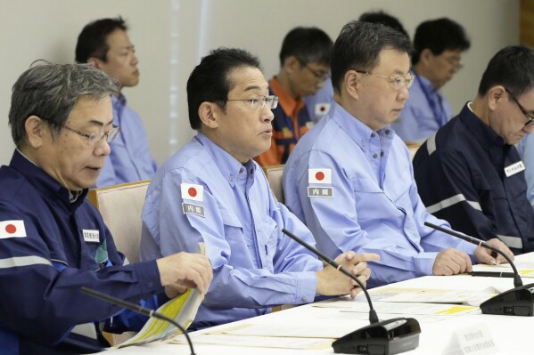 Japanese Prime Minister Fumio Kishida, second left, speaks during a disaster drill at his office in Tokyo Friday, Sept. 1, 2023. On Friday, Japan marked the centennial of the 1923 Great Kanto Quake that killed more than 100,000. (Kyodo News via AP)