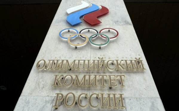 FILE - In this file photo dated Wednesday, Dec. 6, 2017, the logo of the Russian Olympic Committee at the entrance of the head office in Moscow, Russia. The ruling on whether Russia can keep its name and flag for the Olympics will be announced on Thursday Dec. 17, 2020. The Court of Arbitration for Sport said Wednesday that three of its arbitrators held a four-day hearing last month in the dispute between the World Anti-Doping Agency and its Russian affiliate, known as RUSADA. (AP Photo/Pavel Golovkin, File)