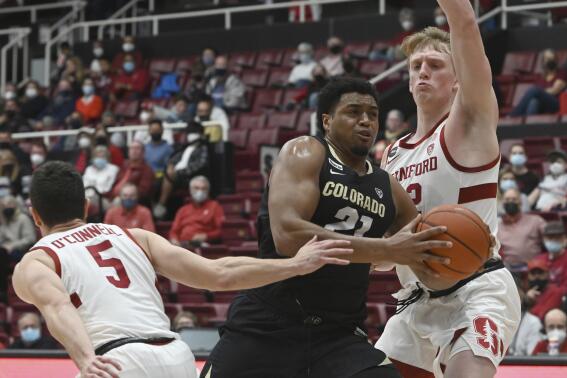 Stanford guard Michael O'Connell (5) and forward James Keefe, right, try to block a layup by Colorado forward Evan Battey (21) during the first half of an NCAA college basketball game in Stanford, Calif., Saturday, Feb. 19, 2022. (AP Photo/Nic Coury)
