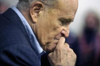 FILE - In this Monday, Oct. 12, 2020, file photo, former New York Mayor Rudy Giuliani pauses while addressing supporters of President Donald Trump during a Columbus Day gathering at a Trump campaign field office in Philadelphia. According to court records unsealed Tuesday, May 4, 2021, federal prosecutors have asked a Manhattan federal judge to appoint a “special master” to oversee the review of materials seized the week before from Giuliani's home. (AP Photo/Jacqueline Larma, File)