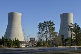 FILE - The cooling towers of the still under construction Plant Vogtle nuclear energy facility in Waynesboro, Ga., Friday, March 22, 2019. One of the owners of the plant announced Saturday, June 18, 2022, that it was freezing its costs and forcing Georgia Power Co. to assume all future overruns, giving up a share of its ownership to Georgia Power. (Michael Holahan/The Augusta Chronicle via AP)