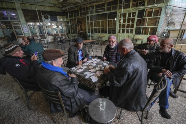 People play cards at a café in Damascus, Syria, on Tuesday, Dec. 10, 2024. (AP Photo/Hussein Malla, File)