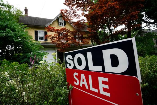 FILE - A sale sign stands outside a home in Wyndmoor, Pa., Wednesday, June 22, 2022. On Friday, the National Association of Realtors reports on sales of existing homes in December. (AP Photo/Matt Rourke, File)