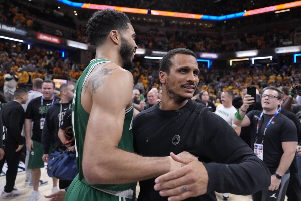 Boston Celtics head coach Joe Mazzulla celebrates with forward Jayson Tatum, left, after Game 4 of the NBA Eastern Conference basketball finals against the Indiana Pacers, Monday, May 27, 2024, in Indianapolis. The Celtics won 105-102.(AP Photo/Michael Conroy)