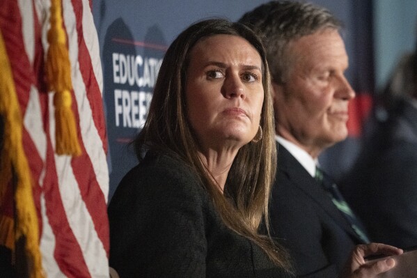 Arkansas Gov. Sarah Huckabee Sanders, left, attends a news conference with Tennessee Gov. Bill Lee, right, Tuesday, Nov. 28, 2023, in Nashville, Tenn. Gov. Lee presented the Education Freedom Scholarship Act of 2024, his administration's legislative proposal to establish statewide universal school choice. (AP Photo/George Walker IV)