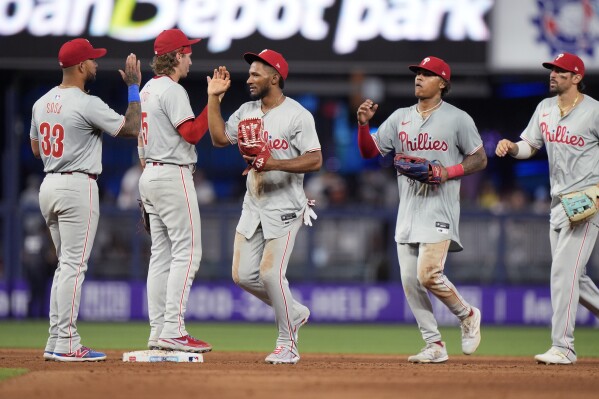 Philadelphia Phillies players celebrate after they beat the Miami Marlins 8-3 in a baseball game, Saturday, May 11, 2024, in Miami. (AP Photo/Wilfredo Lee)