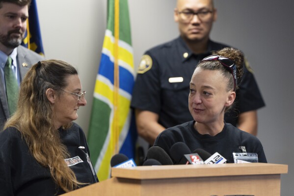 Melissa Smith, mother of Kristin Smith, right, looks to Diana Allen, mother of Charity Lynn Perry, left, as they speak during a news conference on Friday, May 17, 2024, in Portland, Ore., after a grand jury indicted Jesse Lee Calhoun on second-degree murder charges in the deaths of Charity Lynn Perry, 24; Bridget Leanne Webster, 31; and Joanna Speaks, 32. (AP Photo/Jenny Kane)