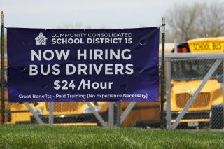 A hiring sign seeking bus drivers stands in Palatine, Ill., Wednesday, April 19, 2023. On Thursday, the Labor Department reports on the number of people who applied for unemployment benefits last week. (AP Photo/Nam Y. Huh)
