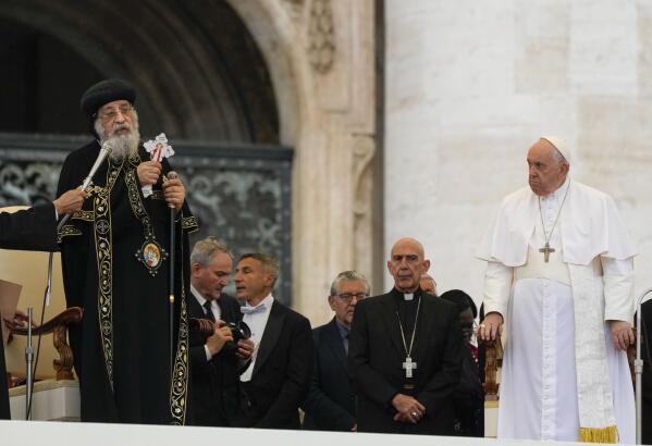 Pope Francis, right, starts his weekly general audience in St. Peter's Square at The Vatican, with the leader of the Coptic Orthodox Church of Alexandria, Tawadros II,Wednesday, May 10, 2023. (AP Photo/Alessandra Tarantino)