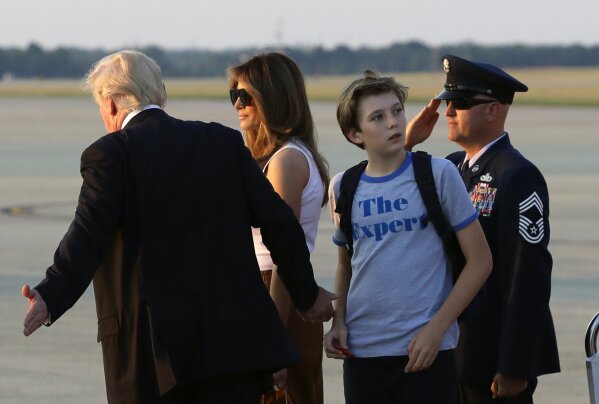 
              Barron Trump, second from right, son of President Donald Trump, looks back at Air Force One after arriving with the president and first lady Melania Trump at Andrews Air Force Base, Md., Sunday, June 11, 2017. Trump was returning to Washington after spending the weekend at Trump National Golf Club in Bedminster, N.J. (AP Photo/Patrick Semansky)
            