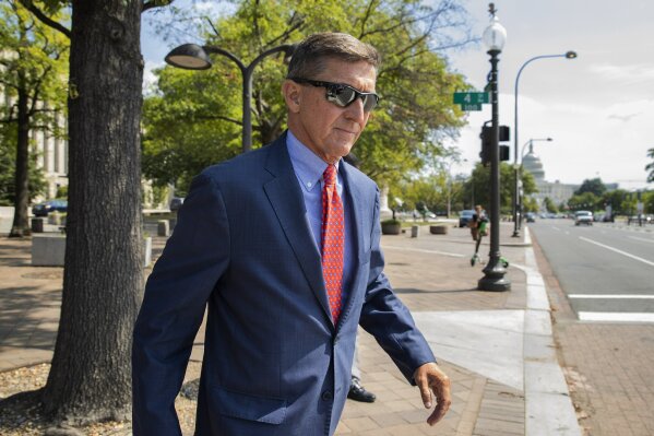 FILE - In this Sept. 10, 2019 file photo, Michael Flynn, President Donald Trump's former national security adviser, leaves the federal court following a status conference in Washington. The arrest of President Donald Trump’s former chief strategist Steve Bannon adds to a growing list of Trump associates ensnared in legal trouble. They include the president's former campaign chair, Paul Manafort, whom Bannon replaced, his longtime lawyer, Michael Cohen, and his former national security adviser, Michael Flynn.  (AP Photo/Manuel Balce Ceneta, File)