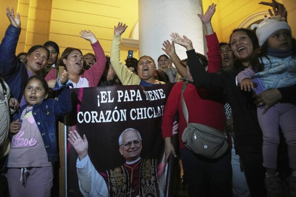 Parishioners hold a photo of Bishop Robert Prevost, elected Pope Leo XIV, after Mass at the Cathedral of Chiclayo, Peru, where he served as bishop for several years, Thursday, May 8, 2025. (AP Photo/Guadalupe Pardo)