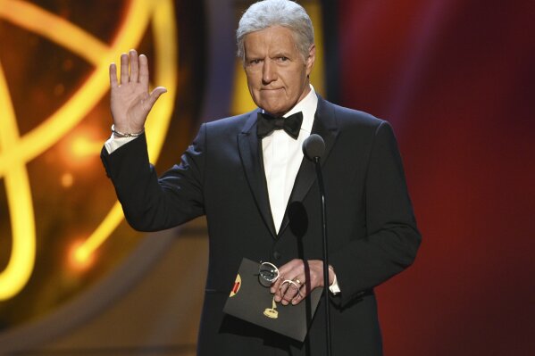 FILE - This May 5, 2019 file photo shows Alex Trebek presenting an award at the 46th annual Daytime Emmy Awards in Pasadena, Calif. The “Jeopardy!” veteran host's nomination for best game show host could give him for a second consecutive win in the category. (Photo by Chris Pizzello/Invision/AP, File)