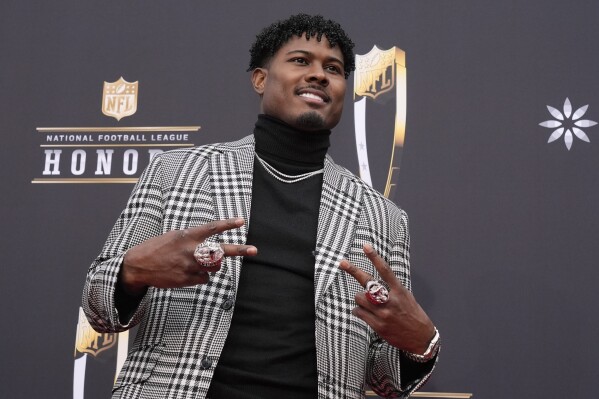 Jonathan Jones of the New England Patriots poses on the red carpet at the NFL Honors award show ahead of the Super Bowl 58 football game Thursday, Feb. 8, 2024, in Las Vegas. (AP Photo/Charlie Riedel)