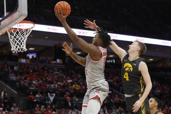 Ohio State's Brice Sensabaugh, left, shoots over Iowa's Josh Dix during the second half of an NCAA college basketball game on Saturday, Jan. 21, 2023, in Columbus, Ohio. (AP Photo/Jay LaPrete)