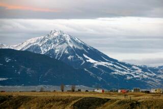 FILE - Emigrant Peak towers over the Paradise Valley in Montana north of Yellowstone National Park, on Nov. 21, 2016. Park County authorities said Friday, March 25, 2022, that a hiker was killed in the area in a suspected encounter with a grizzly bear. (AP Photo/Matthew Brown, File)