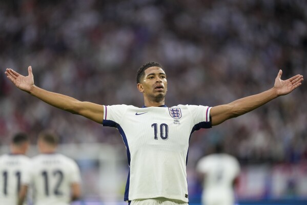 England's Jude Bellingham celebrates after scoring the opening goal during a Group C match between Serbia and England at the Euro 2024 soccer tournament in Gelsenkirchen, Germany, Sunday, June 16, 2024. (AP Photo/Martin Meissner)