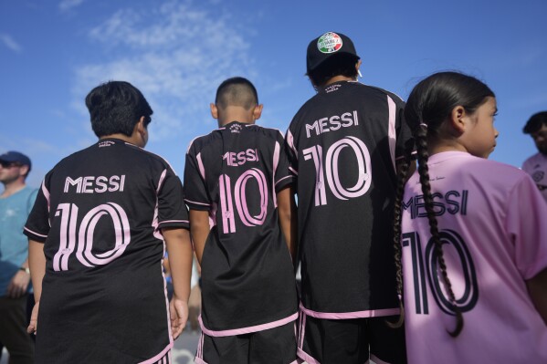 Lionel Messi fans from North Lauderdale, Fla., wait to enter the stadium before a Leagues Cup soccer match between Inter Miami and Cruz Azul, Friday, July 21, 2023, in Fort Lauderdale, Fla. (AP Photo/Rebecca Blackwell)