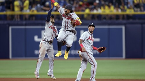 Atlanta Braves' Ronald Acuna Jr., center, celebrates with Ozzie Albies, left, and Orlando Arcia after the team's 2-1 win over the Tampa Bay Rays in a baseball game Friday, July 7, 2023, in St. Petersburg, Fla. (AP Photo/Mike Carlson)