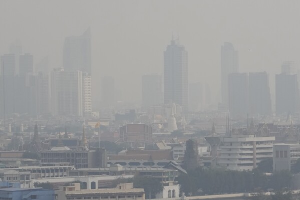 A thick layer of smog covers central in Bangkok, Thailand, Thursday, Feb. 15, 2024. City officials in Thailand’s capital Bangkok were ordered Thursday to work from home for two days, and workers in the private sector were encouraged to do likewise as air pollution soared to unhealthy levels. (AP Photo/Sakchai Lalit)