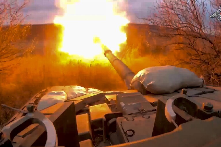 In this photo released by the Russian Defense Ministry on March 19, 2024, a Russian tank fires at Ukrainian troops from a position near the border with Ukraine in Russia’s Belgorod region. (Russian Defense Ministry Press Service via AP, File)