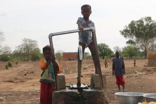 Children play on a water pump in an internally displaced camp in Gaoa, Burkina Faso, April 22, 2021. Until recently life was peaceful in western Burkina Faso's Comoe province, but an increase in attacks by extremist groups in the country's west has put the military on edge. Burkina Faso is experiencing an increase in extremist violence by groups linked to al-Qaida and the Islamic State.(AP Photo/Sam Mednick)