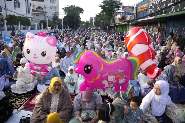 Muslim women attend an Eid al-Fitr prayer marking the end of the holy fasting month of Ramadan in Jakarta, Indonesia, Wednesday, April 10, 2024. (AP Photo/Dita Alangkara)