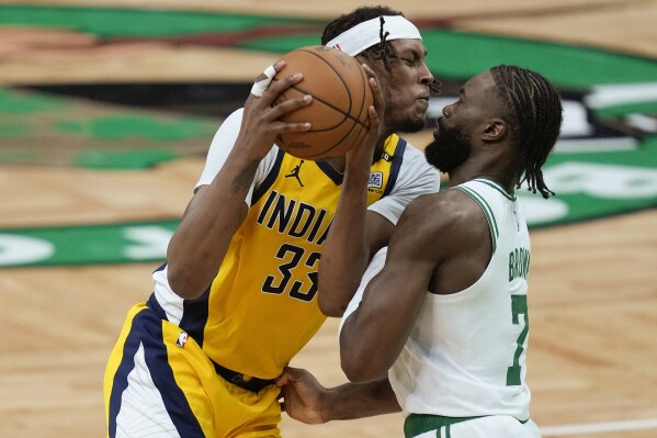 Indiana Pacers center Myles Turner (33) drives against Boston Celtics guard Jaylen Brown (7) during the third quarter of Game 1 of the NBA Eastern Conference basketball finals, Tuesday, May 21, 2024, in Boston. (AP Photo/Charles Krupa)