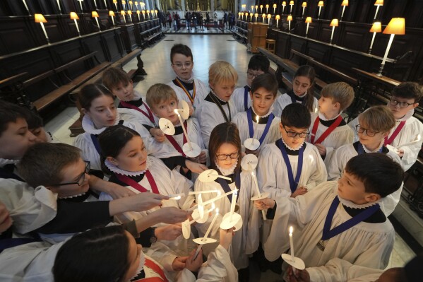 The Choristers of St Paul's choir, including girls for first time in 900-year history, rehearse for the Christmas services in St Paul's Cathedral, in London, Monday, Dec. 23 2024. (AP Photo/Kin Cheung)