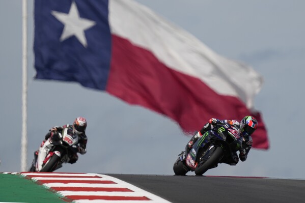 MotoGP rider Alex Rins (42), of Spain, and Takaaki Nakagami (30), of Japan, steer through a turn during qualifying for the MotoGP Grand Prix of the Americas motorcycle race at the Circuit of the Americas, Saturday, April 13, 2023, in Austin, Texas. (AP Photo/Eric Gay)