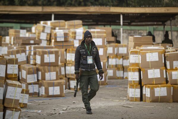 
              A police officer keeps guard over electoral materials still stacked in boxes at the offices of the Independent National Electoral Commission in Kano, in northern Nigeria Saturday, Feb. 16, 2019. Nigeria's electoral commission delayed the presidential election until Feb. 23, making the announcement a mere five hours before polls were set to open Saturday. (AP Photo/Ben Curtis)
            