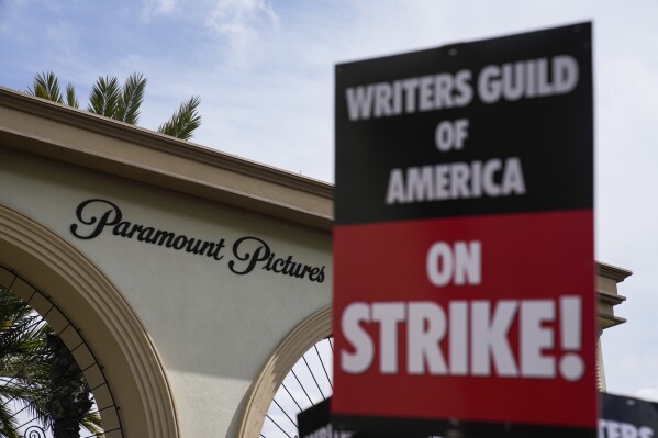 FILE - Members of the The Writers Guild of America picket outside Paramount Pictures on May 3, 2023, in Los Angeles. Hollywood productions and promotional tours around the world have been put on indefinite hold as actors and writers are on strike against big studios and streaming services.(AP Photo/Ashley Landis)