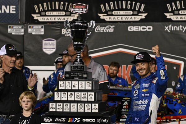 Kyle Larson, right, celebrates in Victory Lane after winning a NASCAR Cup Series auto race at Darlington Raceway, Sunday, Sept. 3, 2023, in Darlington, S.C. (AP Photo/Matt Kelley)