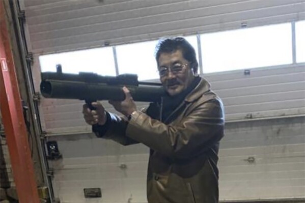 This image provided by the U.S. Attorney, Southern District of New York shows a photo from a complaint document filed by SDNY that shows Takeshi Ebisawa handling a rocket launcher. Federal prosecutors say the leader of a Japan-based crime syndicate conspired to traffic uranium and plutonium from Myanmar in the belief that Iran would use it for nuclear weapons. Prosecutors said Wednesday, Feb. 21, 2024, that Ebisawa and his confederates showed samples of nuclear materials transported from Myanmar to Thailand to a Drug Enforcement Administration undercover agent posing as a narcotics and weapons trafficker who had access to an Iranian general. (U.S. Attorney, Southern District of New York via AP)