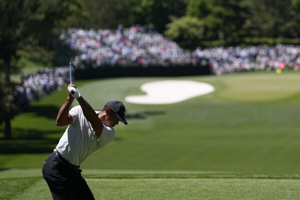 Tiger Woods hits his tee shot on the fourth hole during third round at the Masters golf tournament at Augusta National Golf Club Saturday, April 13, 2024, in Augusta, Ga. (AP Photo/George Walker IV)
