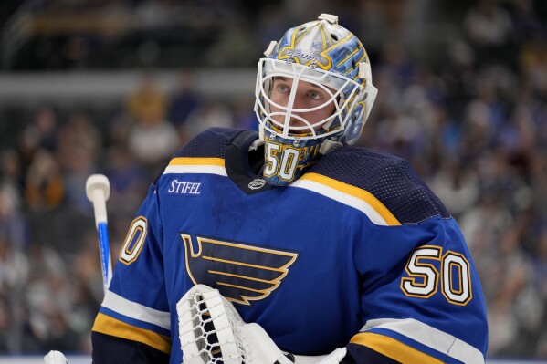 St. Louis Blues goaltender Jordan Binnington pauses during the first period of a preseason NHL hockey game against the Columbus Blue Jackets Tuesday, Sept. 26, 2023, in St. Louis. (AP Photo/Jeff Roberson)