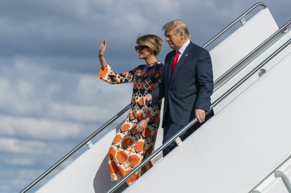 Former President Donald Trump and Melania Trump wave as they disembark from their final flight on Air Force One at Palm Beach International Airport in West Palm Beach, Fla., Wednesday, Jan. 20, 2021. (AP Photo/Manuel Balce Ceneta)