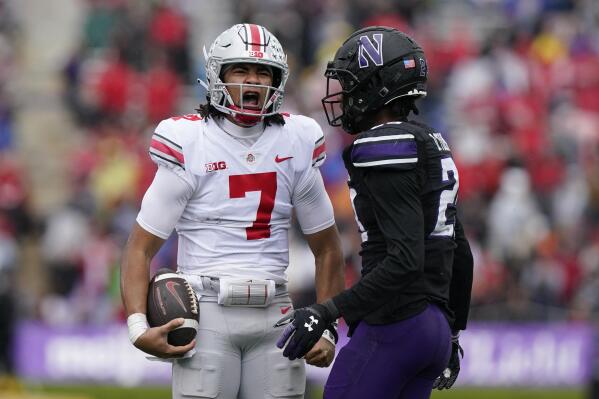 Ohio State quarterback C.J. Stroud, left, reacts after long run against Northwestern defensive back Jack Oyola during the first half of an NCAA college football game, Saturday, Nov. 5, 2022, in Evanston, Ill. Ohio State won 21-7. (AP Photo/Nam Y. Huh)