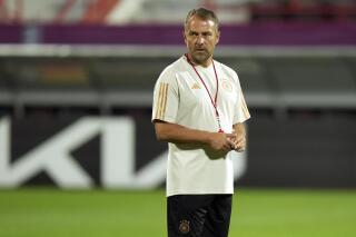 FILE - Germany's head coach Hansi Flick watches his team during a training session at the Al-Shamal stadium on the eve of the group E World Cup soccer match between Germany and Costa Rica, in Al-Ruwais, Qatar, Wednesday, Nov. 30, 2022. Germany coach Hansi Flick picked five uncapped players Friday, March 17, 2023, for upcoming friendlies in an experimental first squad since being eliminated in the group stage at the World Cup. (AP Photo/Matthias Schrader, File)