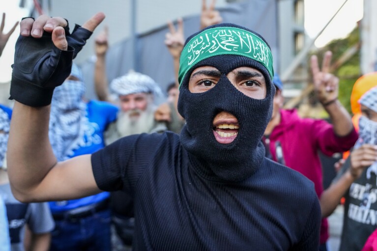FILE - A Palestinian living in Lebanon chants slogans against Britain as he takes part in a protest near the British embassy in Beirut, in solidarity with the Palestinian people in Gaza on Nov. 14, 2023. The Arabic on the headband reads: "No God but Allah and Muhammed is his messenger." (AP Photo/Hassan Ammar, File)