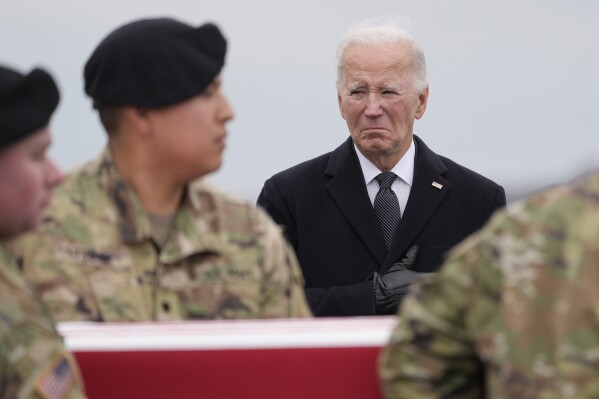 President Joe Biden watches as an Army carry team moves the flag-draped transfer case containing the remains of U.S. Army Sgt. Breonna Alexsondria Moffett, 23, of Savannah, Ga., during a casualty return at Dover Air Force Base, Del., Friday, Feb. 2, 2024. Moffett was killed in a drone attack in Jordan on Jan. 28. (AP Photo/Alex Brandon)