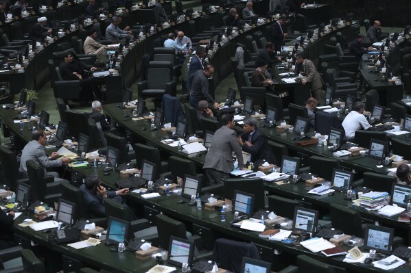 Iranian lawmakers attend an open session of the parliament in Tehran, Iran, Sunday, Aug. 6, 2023. (AP Photo/Vahid Salemi)