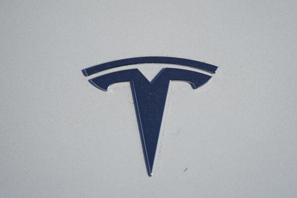 FILE - in this Sunday, Jan. 24, 2021, file photo, the company logo shines off the hood of an unsold 2021 Model 3 sedan at a Tesla dealership, in Littleton, Colo. Two key groups that offer automobile safety ratings have yanked their top endorsements of some Tesla vehicles because the company has stopped using radar on its safety systems. (AP Photo/David Zalubowski, File)